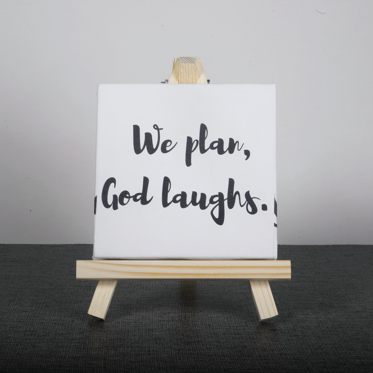 Easel Stand with Mini Canvas Motivational Quote “We plan god laughs” for Office/Desk Decor/Home Decoration/Gift Purpose/Table Decorative Showpiece.