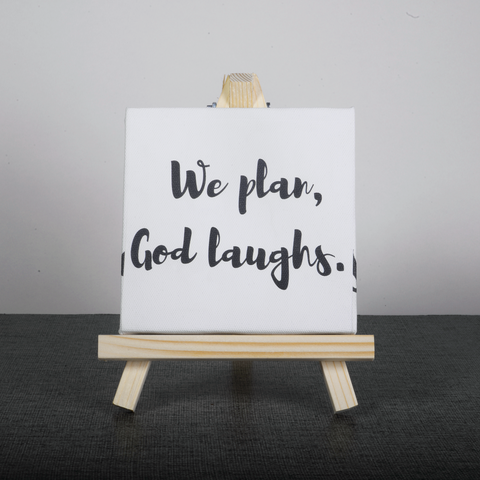 Easel Stand with Mini Canvas Motivational Quote “We plan god laughs” for Office/Desk Decor/Home Decoration/Gift Purpose/Table Decorative Showpiece.